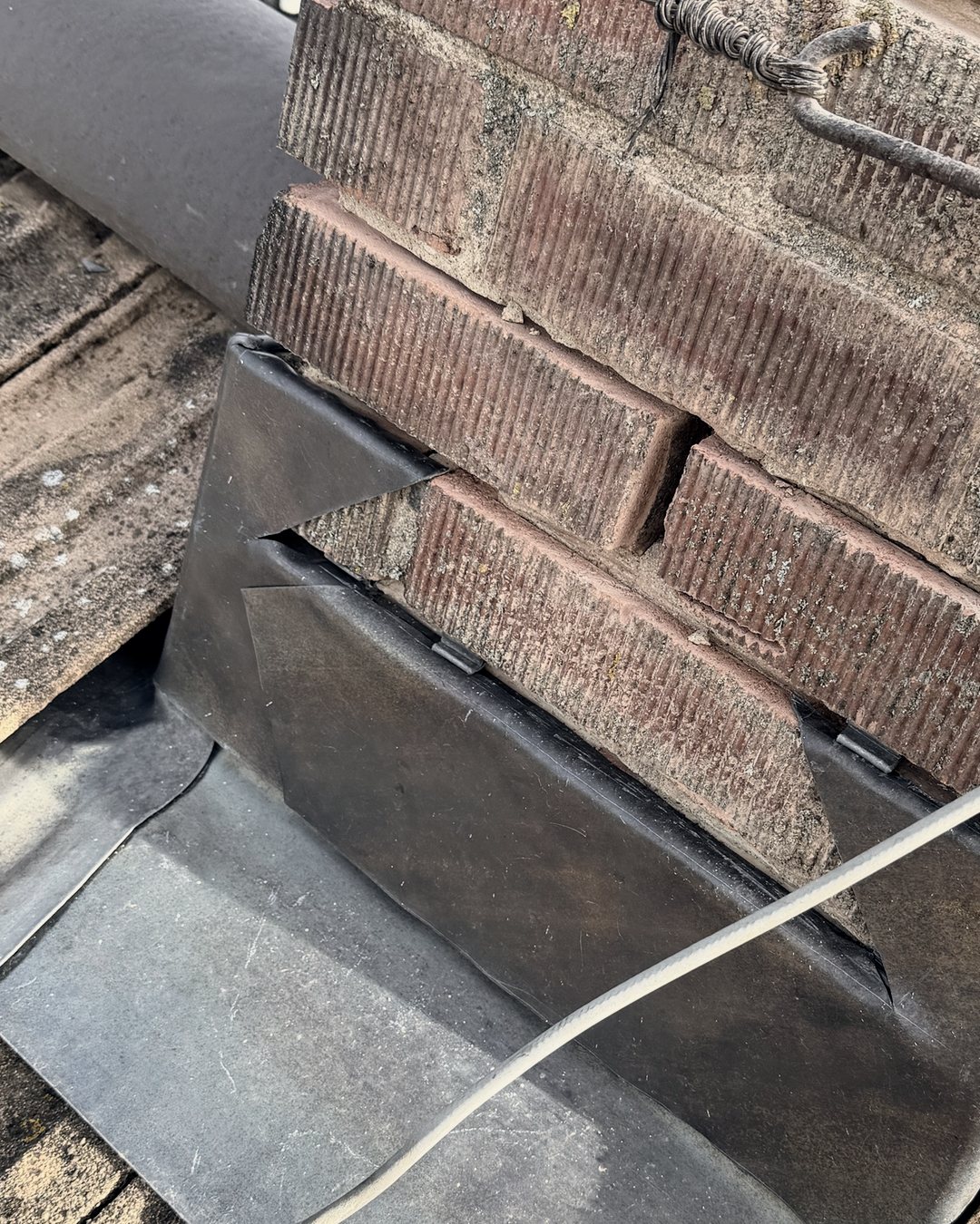 New lead back gutter and flashings round the base of a brick chimney, seen from above