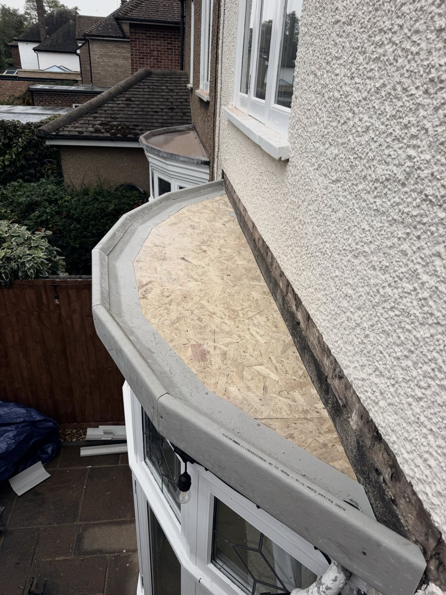 The lead stripped off, with new deck boards and new grey edge trims round the bay