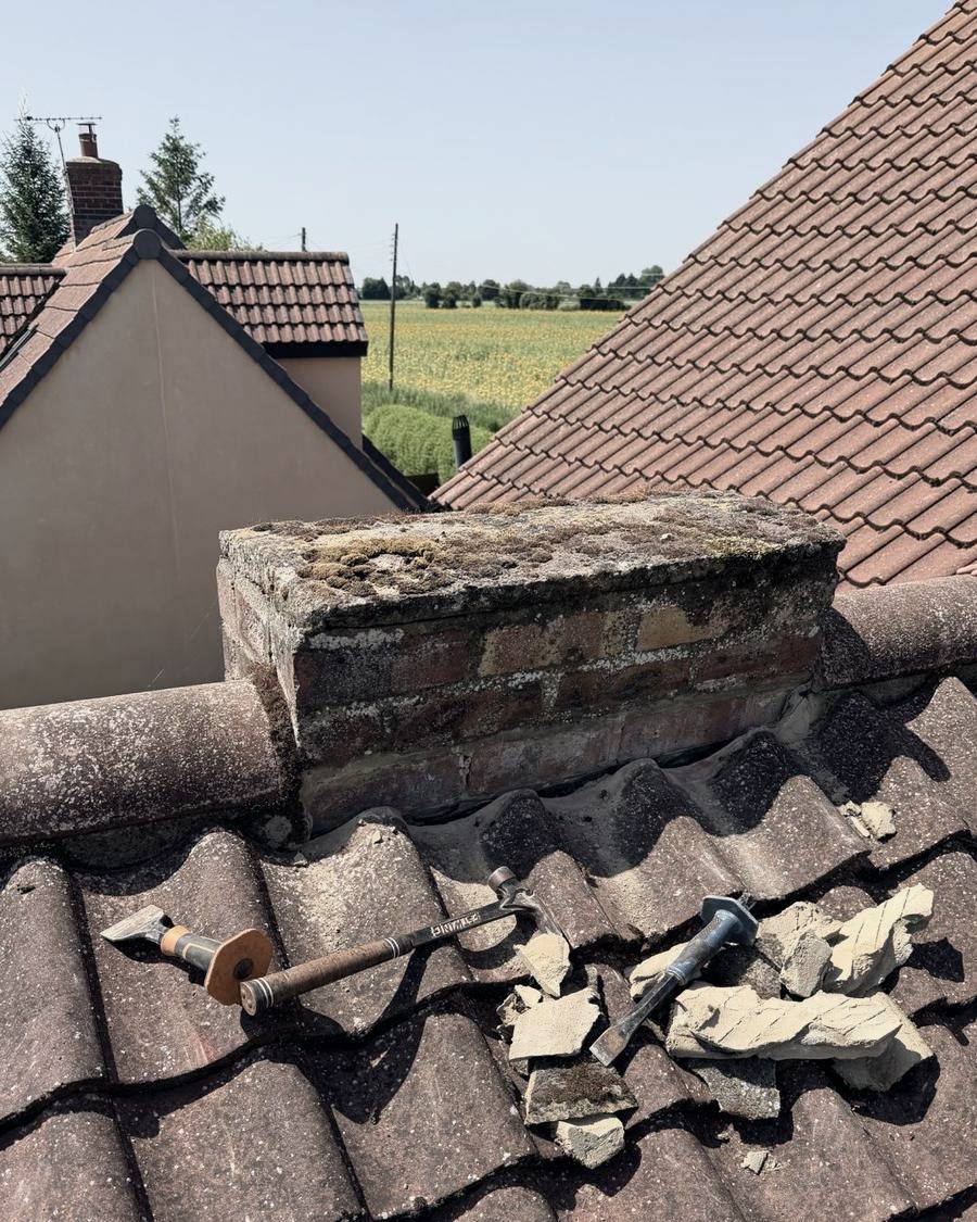 Before: old cement fillet chipped out from around the chimney base