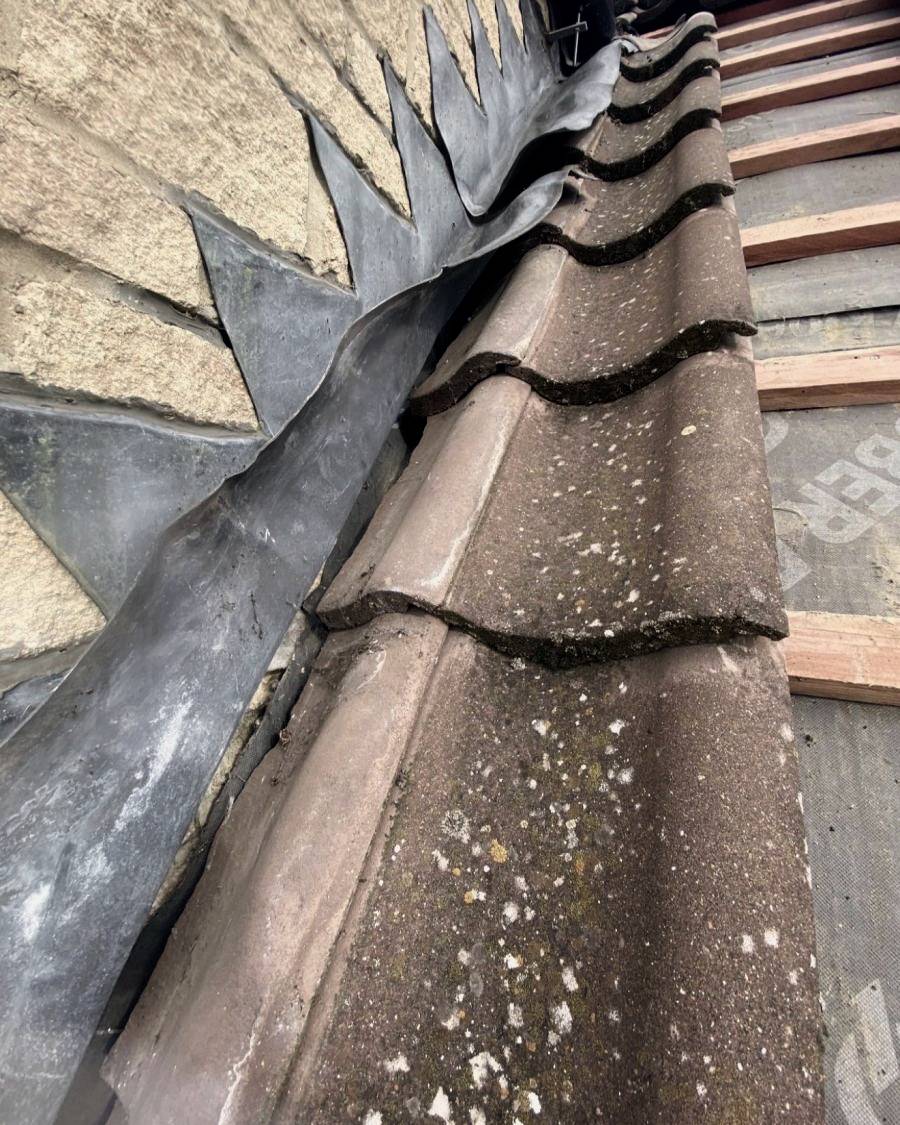 Before: old lead flashing lifting away from a stone wall