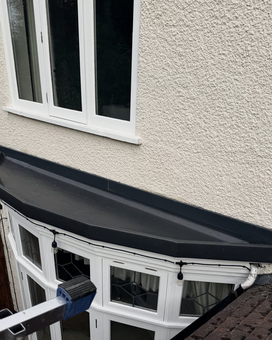 After: the bay roof covered in fibreglass with a dark grey topcoat