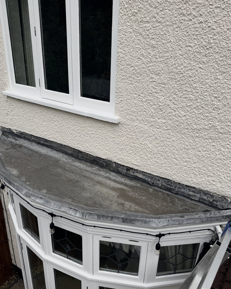 Before: the old lead roof over a bay window, worn and stained
