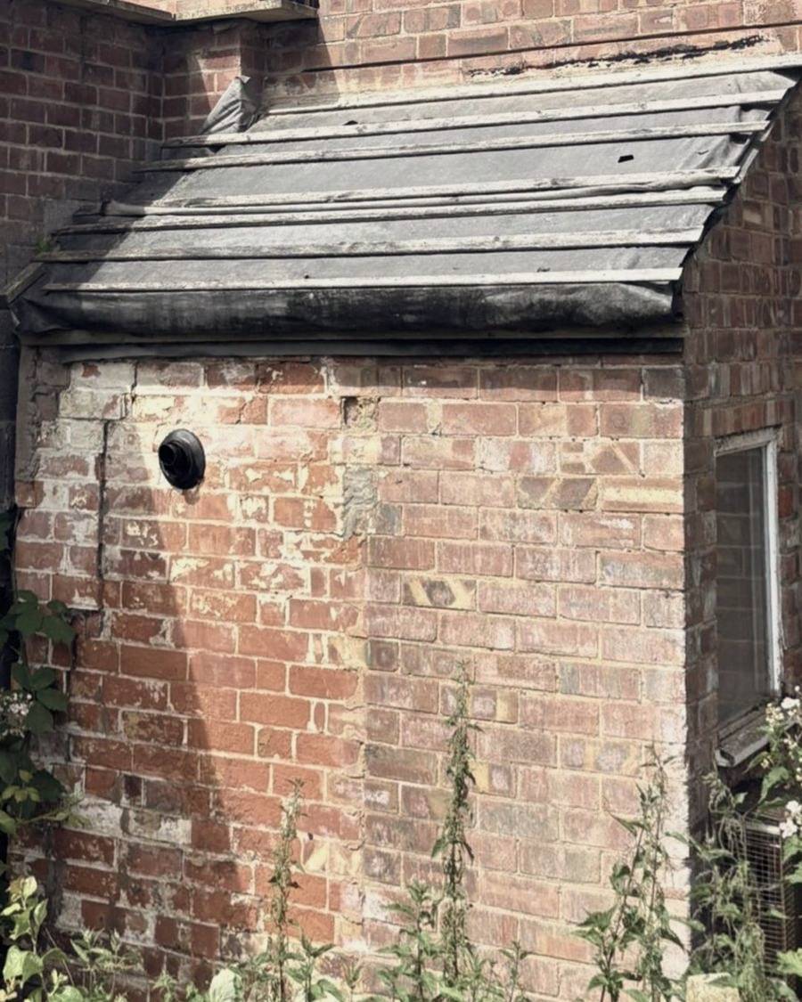 Before: worn felt and battens on a brick lean-to roof