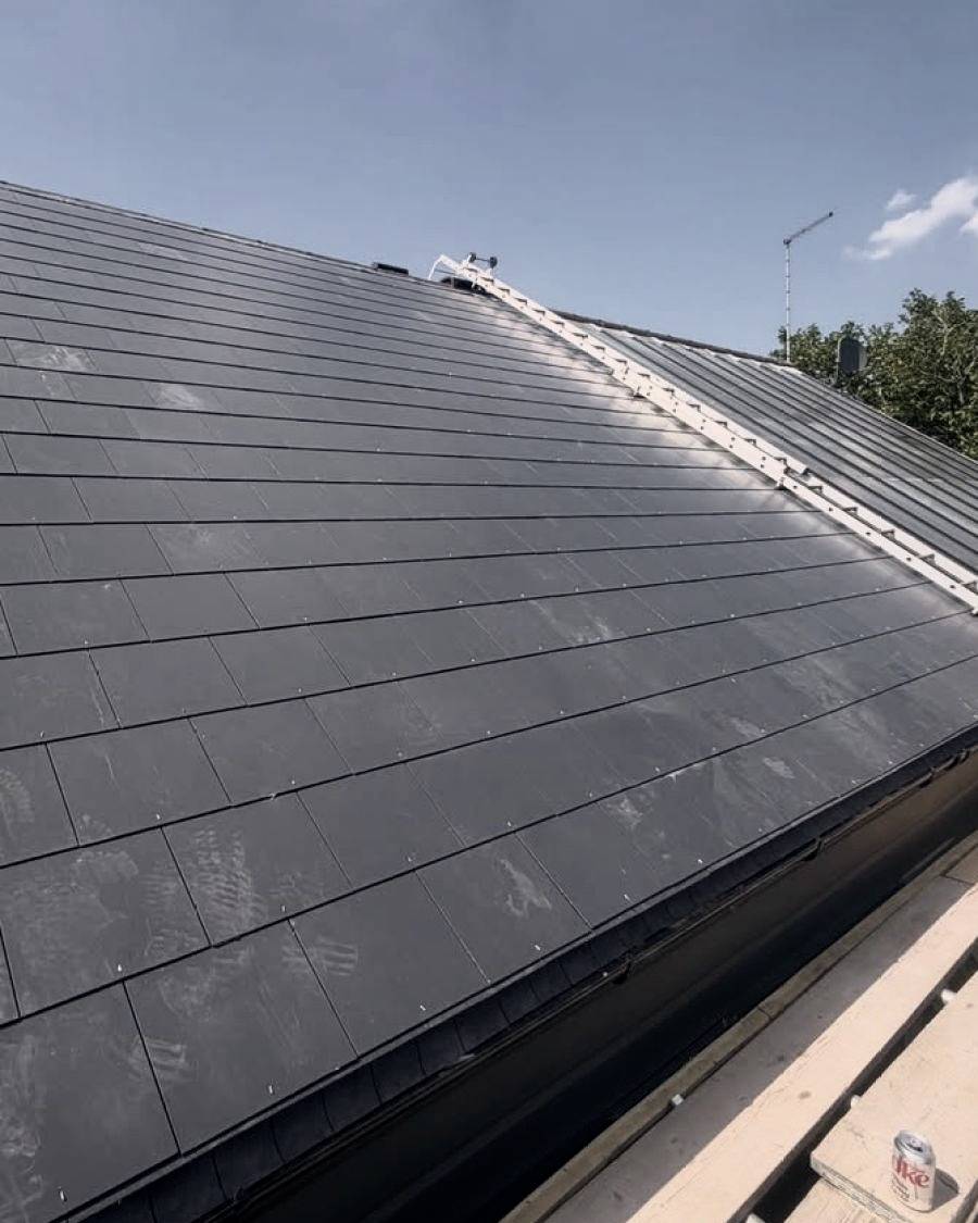 After: the same section of roof re-covered in new slates