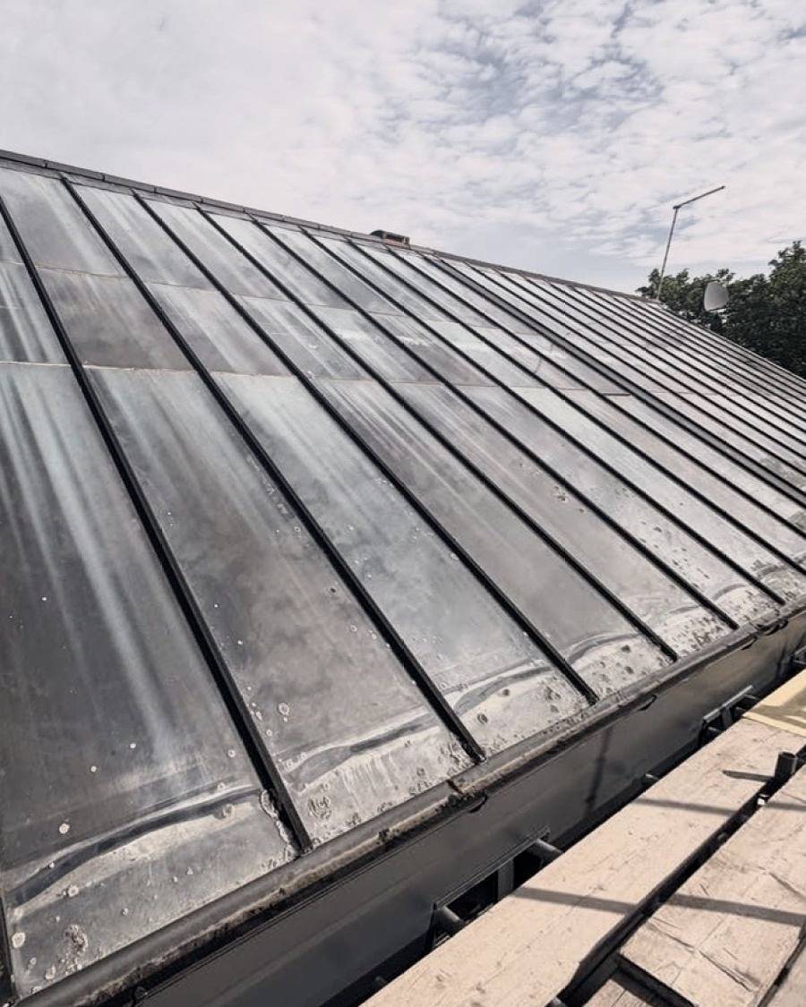 Before: old glazed roof panels, stained and taped